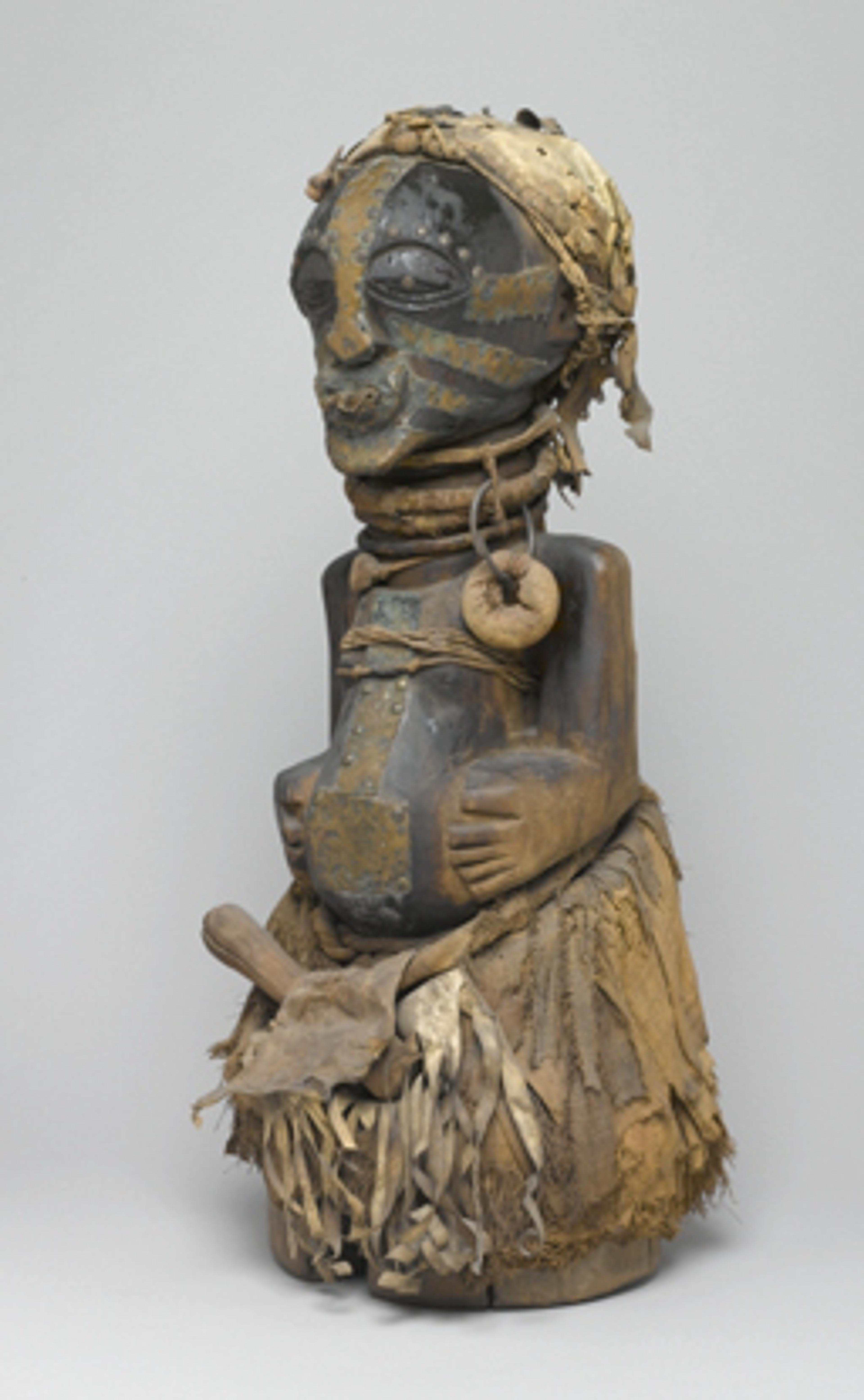 Power Figure (Nkishi). Unidentified Songye artist, 19th or 20th century. East Kasai province, Democratic Republic of the Congo. Wood, raffia, metal, cloth, leather, horn, beads, 30 × 12 × 143⁄4 in. (76.2 × 30.5 × 37.5 cm). Museum Collection Fund, 50.79