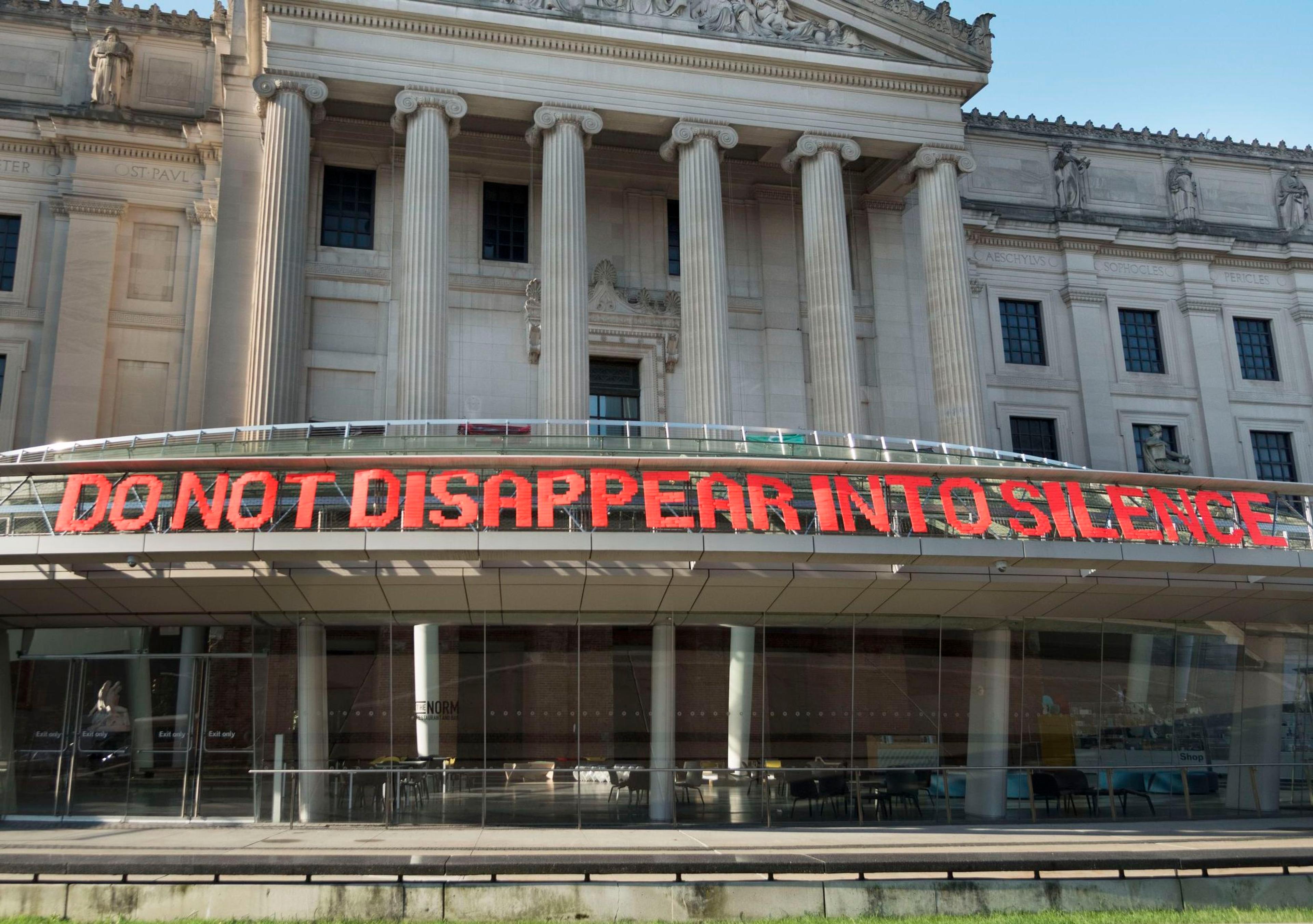 Brooklyn Hi-Art! Machine (established 2010; Mildred Beltré and Oasa DuVerney). DO NOT DISAPPEAR INTO SILENCE, 2014/18. Ribbon, PVC-coated galvanized steel fence, 36 x 1200 in. (91.4 x 3048 cm). Courtesy of Brooklyn Hi-Art! Machine. © Brooklyn Hi-Art! Machine. (Photo: Jonathan Dorado)