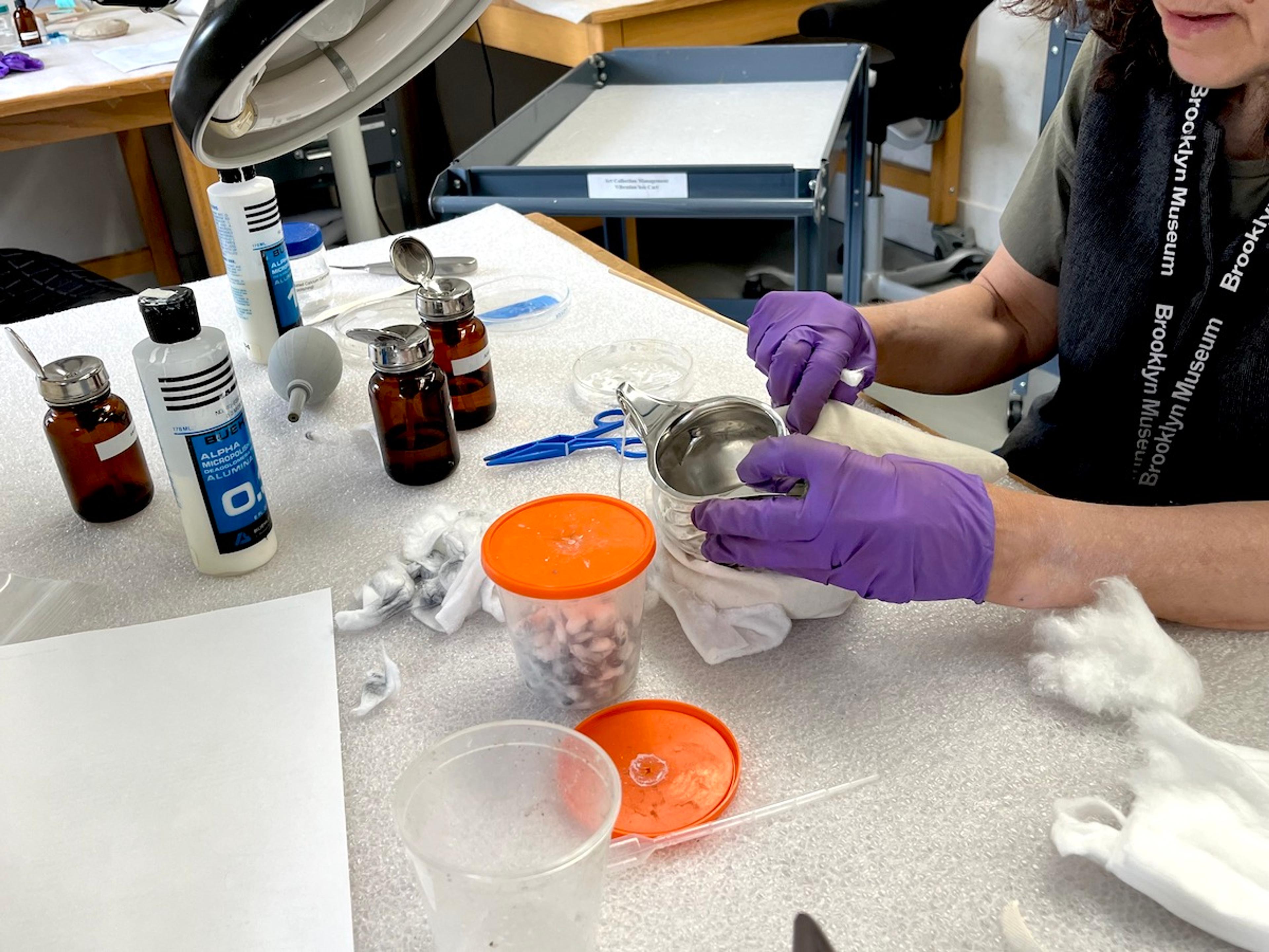 Carol Lee Shen Chief Conservator Lisa Bruno works with an object in the conservation lab at the Brooklyn Museum. (Photo: Corinne Segal)