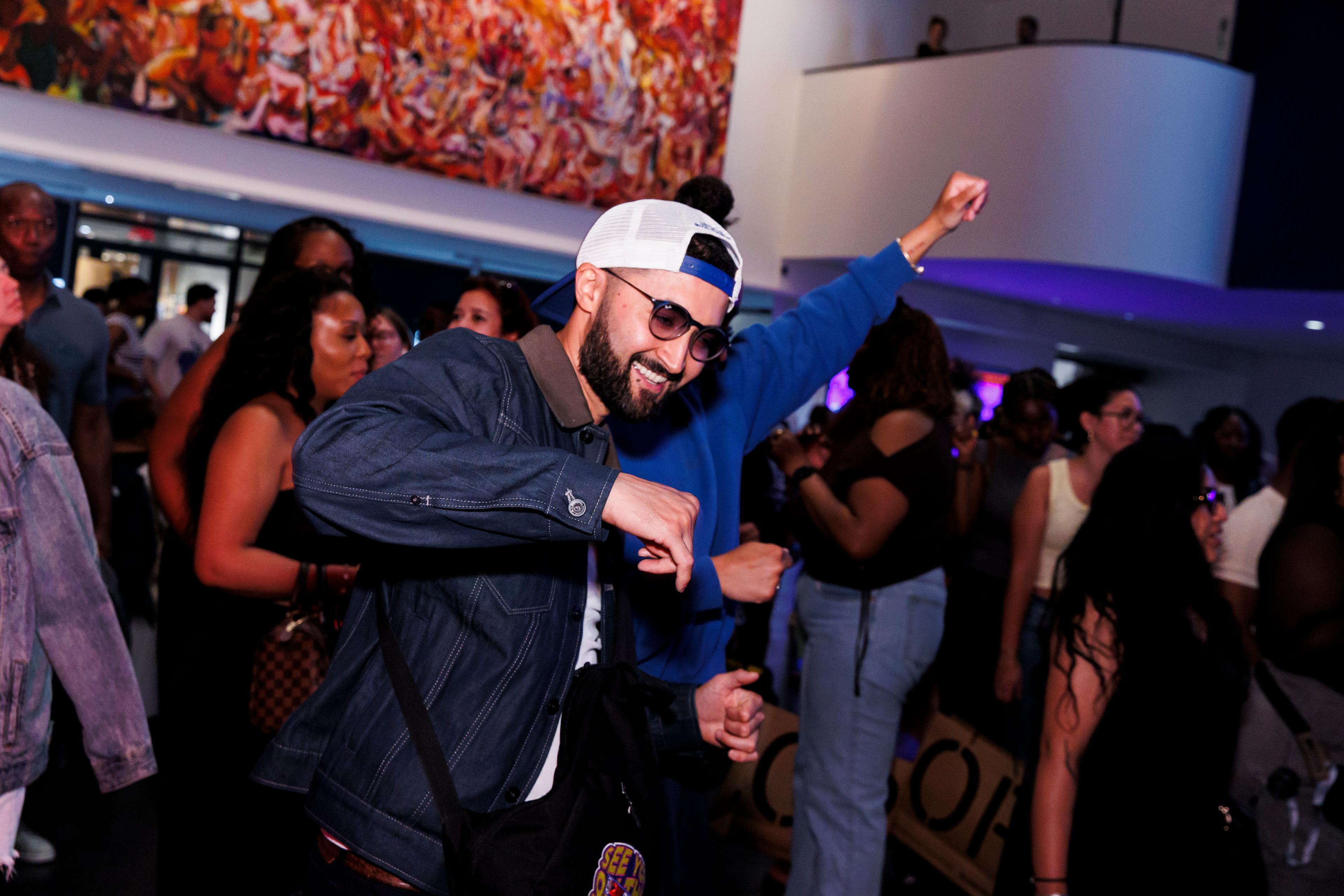 A person in a crowd smiling and dancing